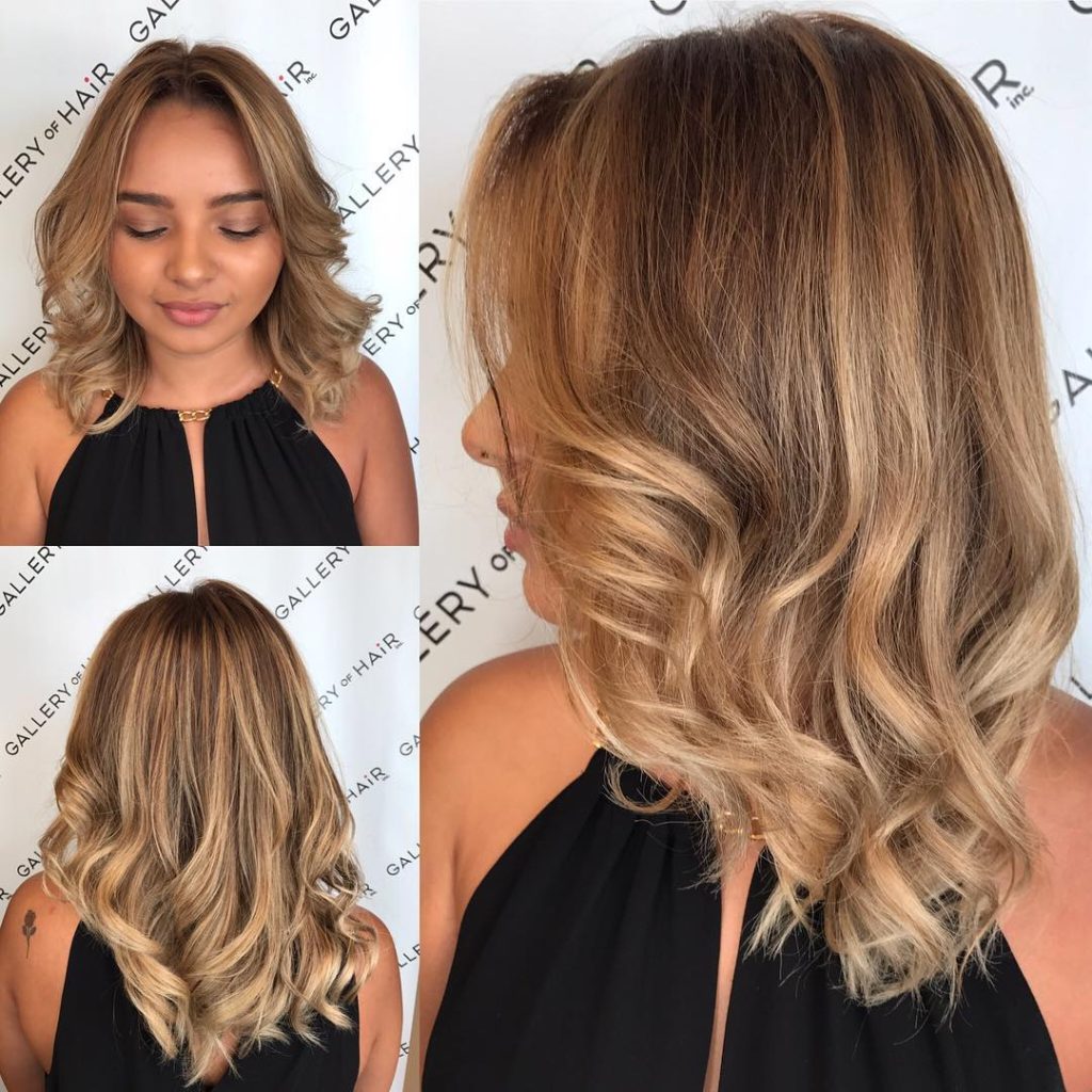Blonde Sun Kissed Layered Cut with Large Soft Waves and Parted Face Framing Layers Medium Length Hairstyle