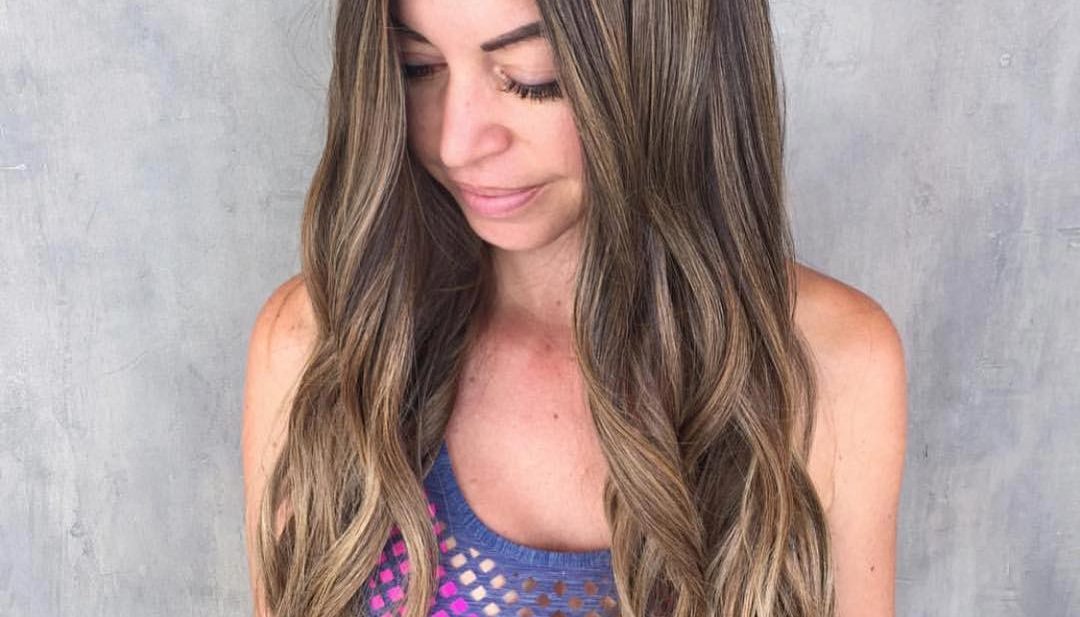 Boho Chic Layered Hair with Wavy Beach Texture and Sun Kissed Bronde Balayage Long Summer Hairstyle