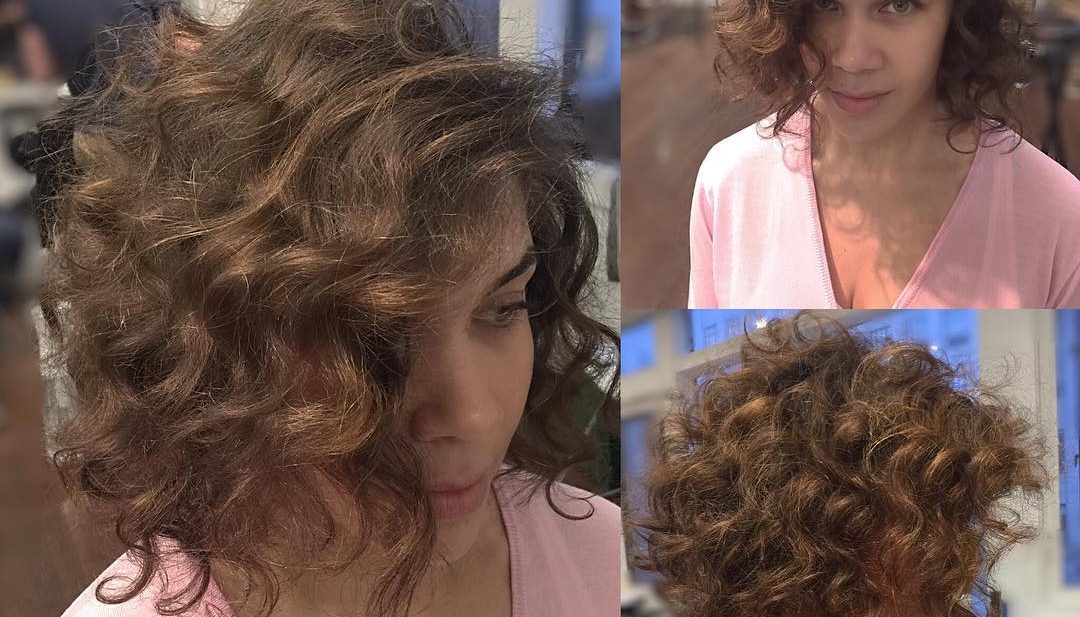 Brunette Angled Bob with Large Soft Curls and Side Part Short Hairstyle