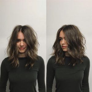 Brunette Layered Cut with Messy Wavy Texture and Center Part Medium Length Hairstyle