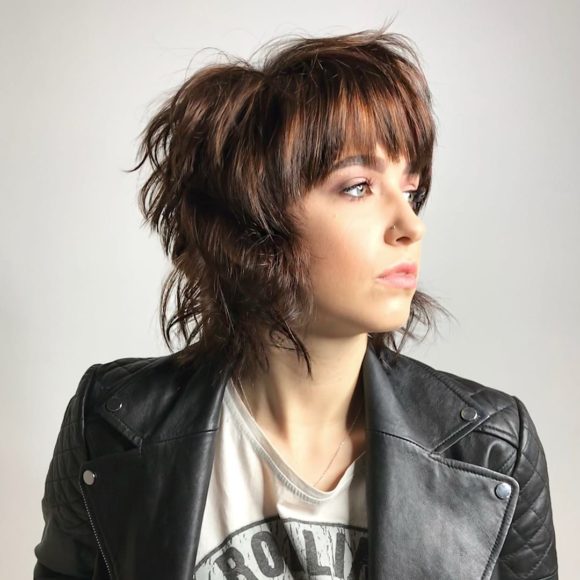 Brunette Shaggy Mod Bob with Undone Textured Waves and Brow Skimming Bangs Medium Length Hairstyle
