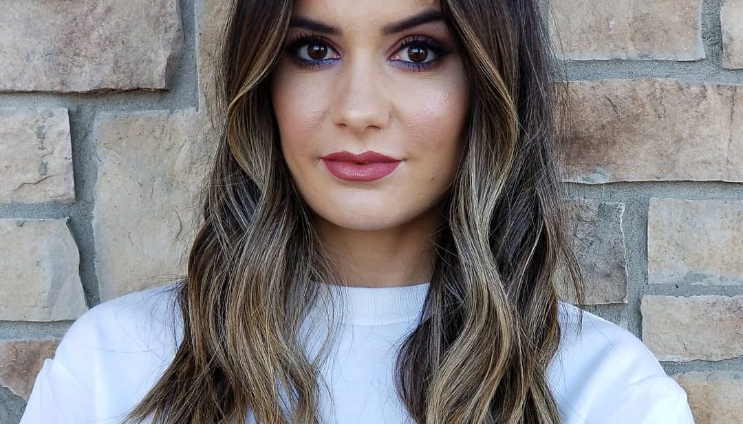 Center Parted Past the Shoulders Layered Cut with Wavy Texture and Dark Brunette to Blonde Color Melt Balayage Medium Length Summer Hairstyle