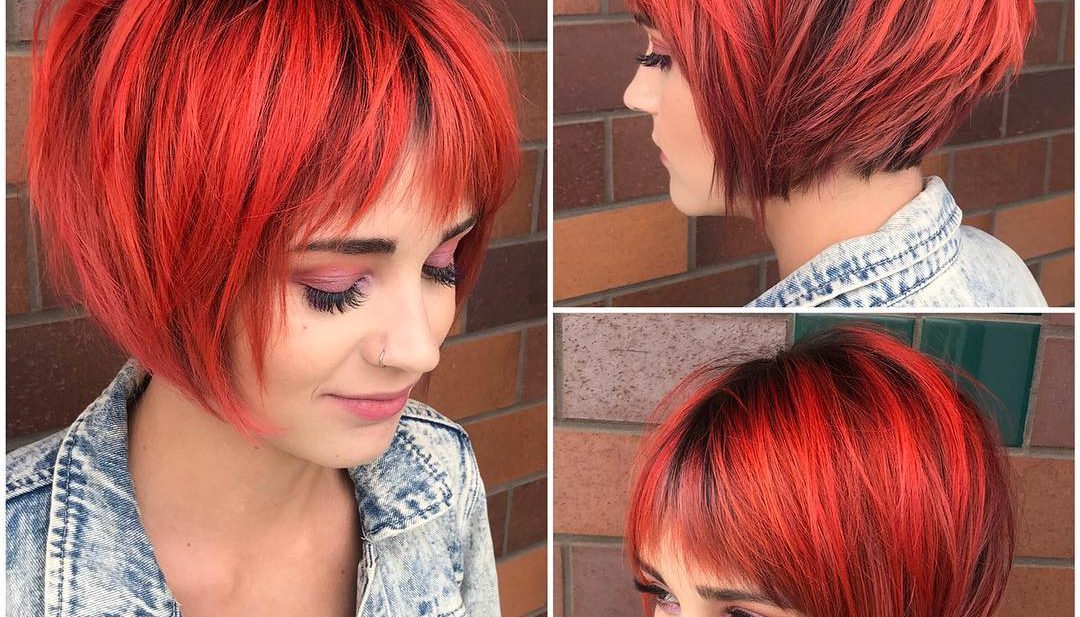 Choppy Red Graduated Bob with Fringe Bangs and Black Shadow Roots Short Hairstyle