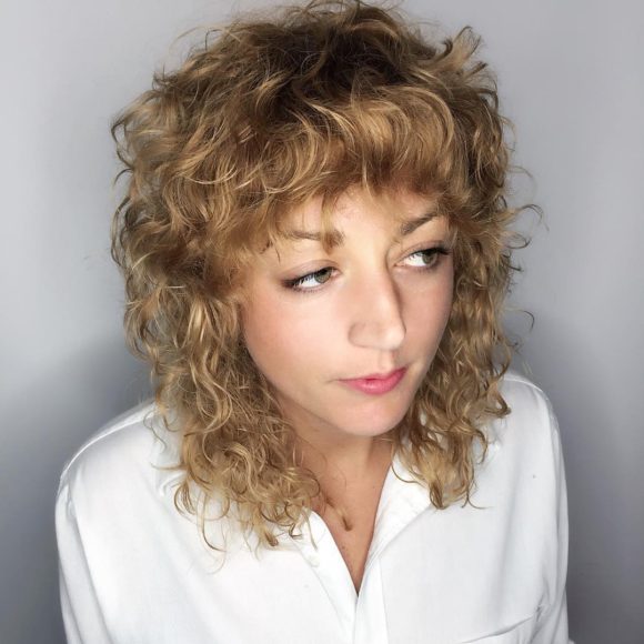 Curly Layered Fringe Cut with Bangs and Dark Blonde Color