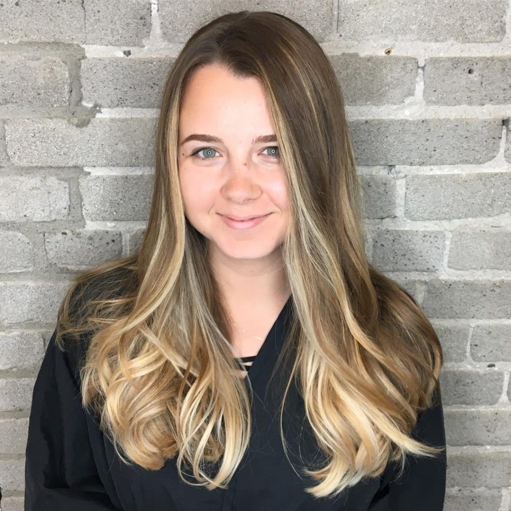 Dark Blonde Blowout with Seamless Layers and Sun Kissed Balayage Highlights Long Hairstyle