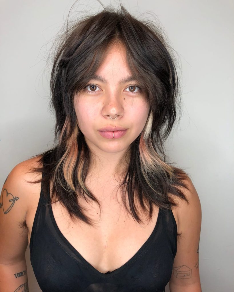 Edgy Brunette Curtain Banged Shag with Messy Natural Texture and Pink and Blonde Peek-a-Boo Highlights Medium Length Summer Hairstyle