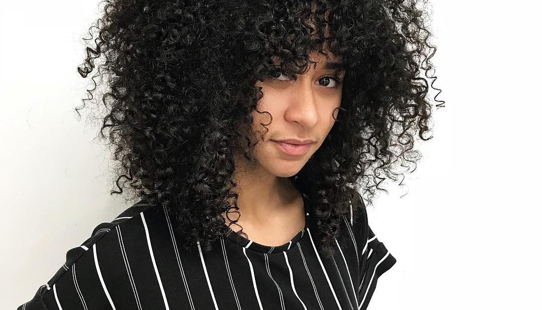 Face Framing Fringe Cut with Natural Curly Texture and Volume on Black Hair Long Trendy Afro Hairstyle
