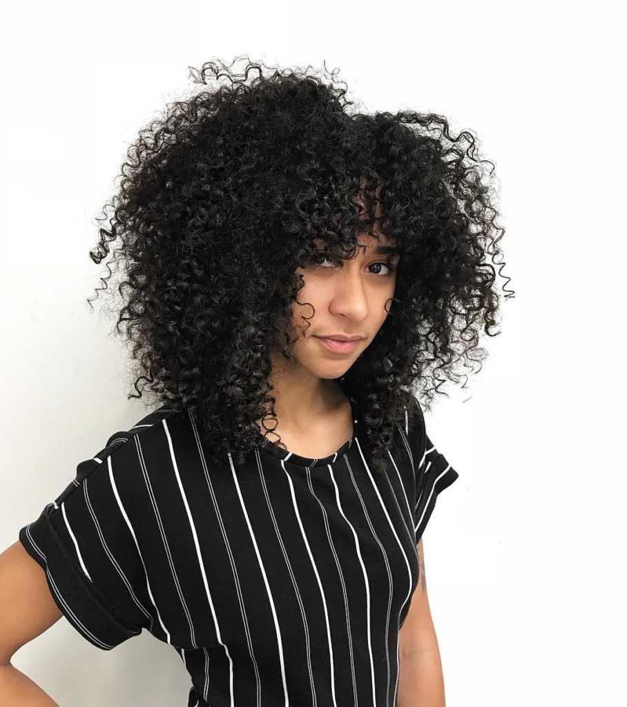 Face Framing Fringe Cut with Natural Curly Texture and Volume on Black Hair Long Trendy Afro Hairstyle