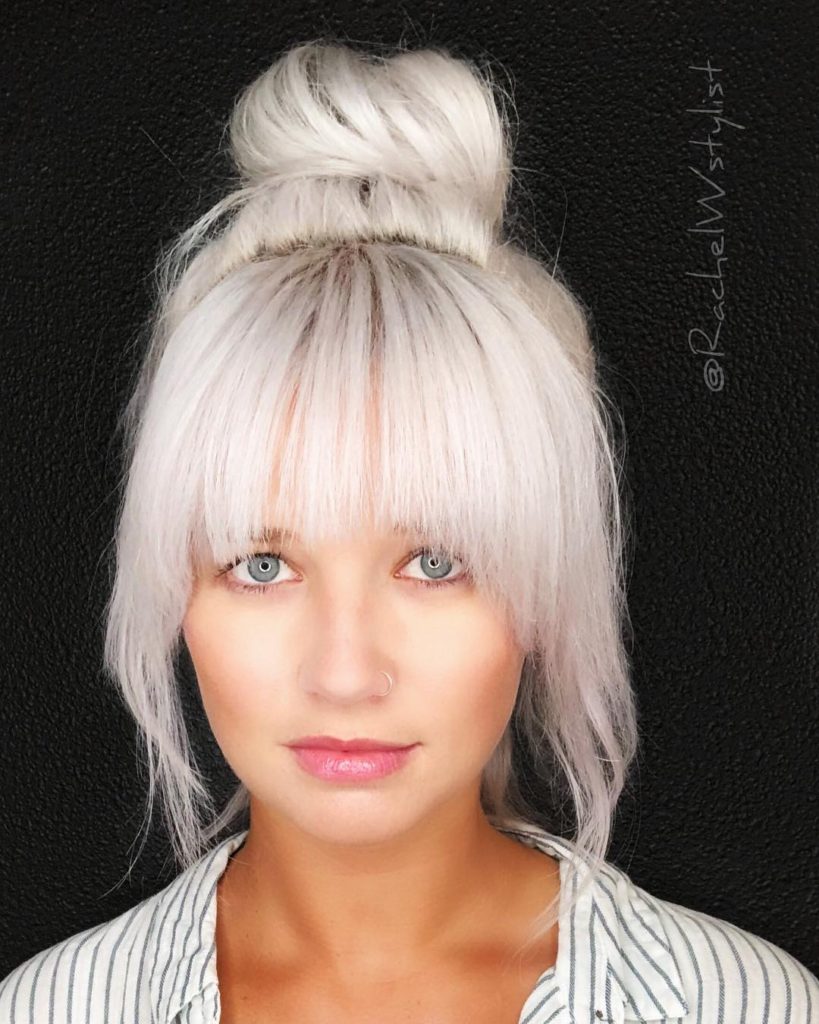 Large Messy Top Bun with Full Face Framing Fringe and Platinum Blonde Hair Color Longhair Updo Fall Hairstyle