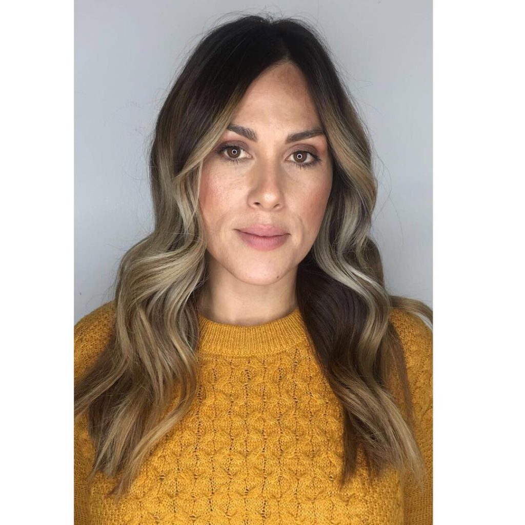 Subtle Layered Cut with Bombshell Wavy Texture and Light Brown Balayage Color Medium to Long Chic Polished Fall Hairstyle