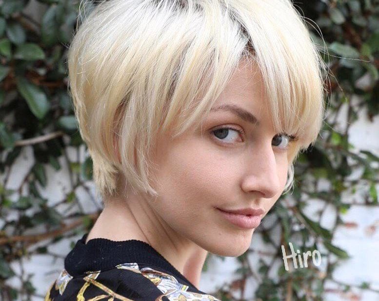 Layered Platinum Blonde Pixie with Messy Textured Fringe and Side Swept Bangs Short Summer Hairstyle