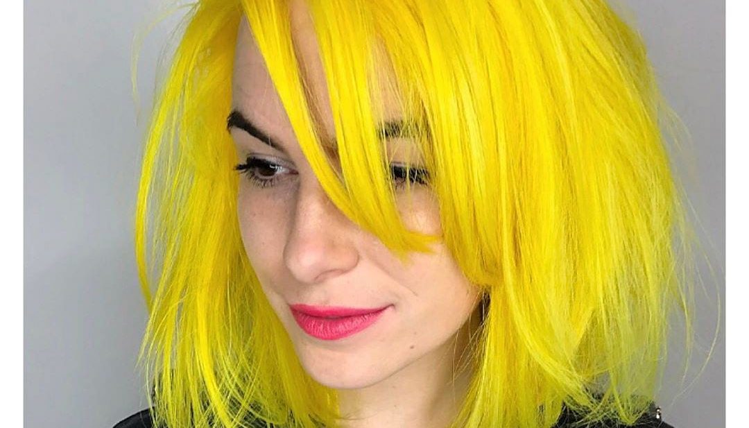 Layered Yellow Sunshine Lob with Undone Blowout Texture and Long Side Swept Bangs Medium Length Summer Hairstyle