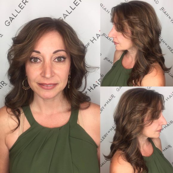 Long Layered Cut with Parted Bangs and Wavy Curls with Soft Brunette Balayage