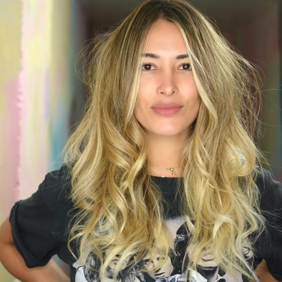 Long Layered Cut with Voluminous Messy Wavy Texture and Golden Blonde Balayage Color