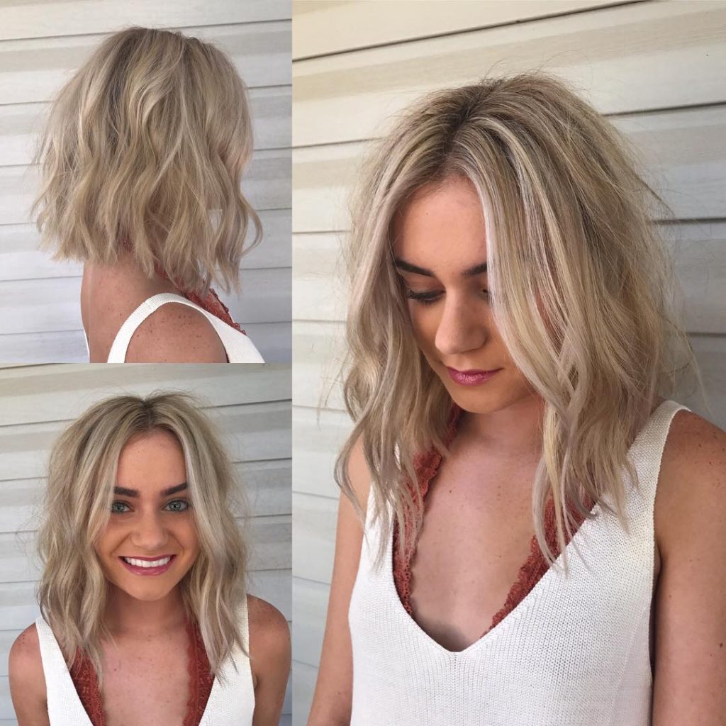 Long Light Blonde Angled Bob With Wavy Beach Textured Layers And Babylights The Latest Hairstyles For Men And Women 2020 Hairstyleology