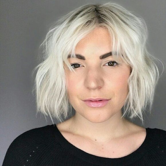 Messy Platinum Textured Bob with Parted Bangs and Shadow Roots