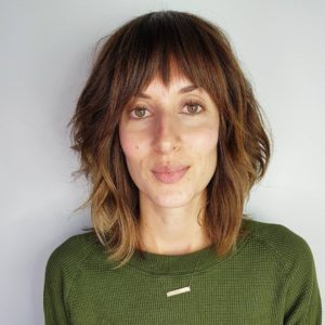 Modern Soft Wavy Shag Cut with Fringe Bangs and Sun Kissed Caramel ...