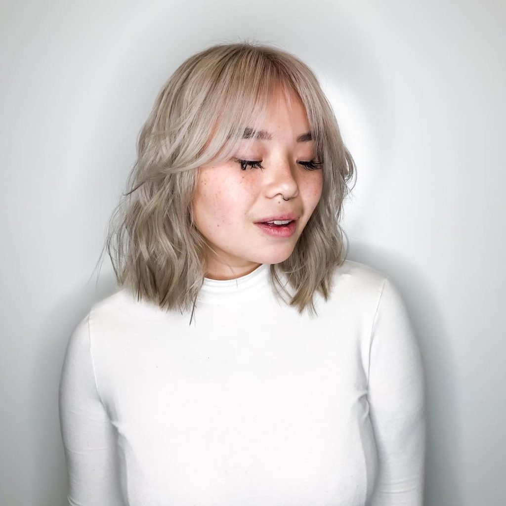 Platinum Wavy Bob with Seamless Layers and Curtain Bangs Medium Length Hairstyle