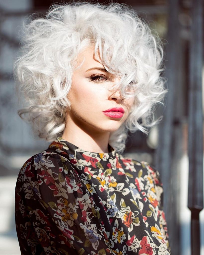 Sexy Platinum Mod Bob with Allover Messy Curly Texture and Long Side Swept Curly Bangs Medium Length Retro Fall Hairstyle