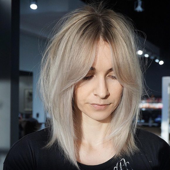 Shaggy Curtain Banged Lob with Undone Straight Texture and Platinum Blonde Color Medium Length Hairstyle