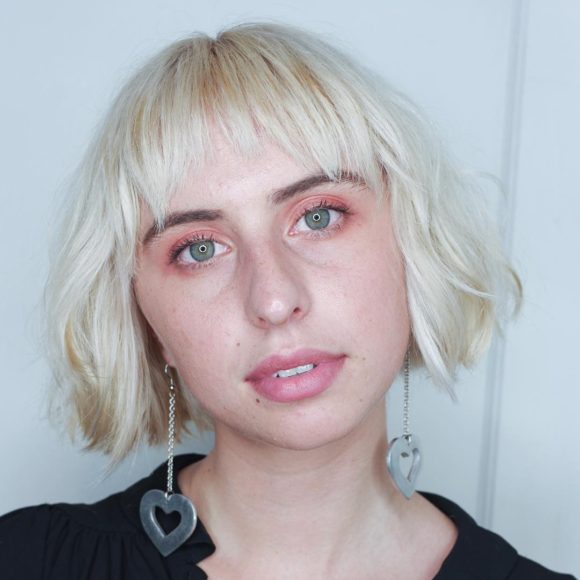 Short Platinum Razor Cut Bob with Baby Fringe Bangs and Soft Undone Waves