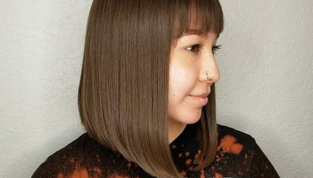 Sleek Angled Lob with Brow Skimming Bangs and Chocolate Brown Hair Color Medium Length Hairstyle