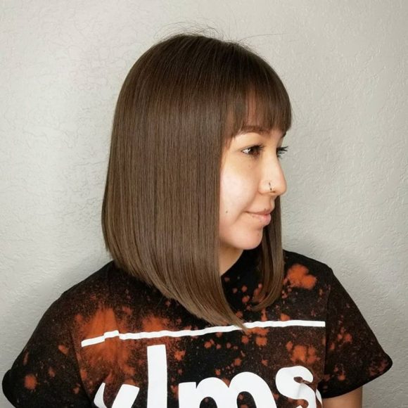 Sleek Angled Lob with Brow Skimming Bangs and Chocolate Brown Hair Color