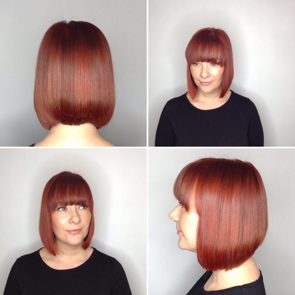 Sleek Collapsed Bob with Full Brow Skimming Bangs and Rich Auburn Color Medium Length Hairstyle