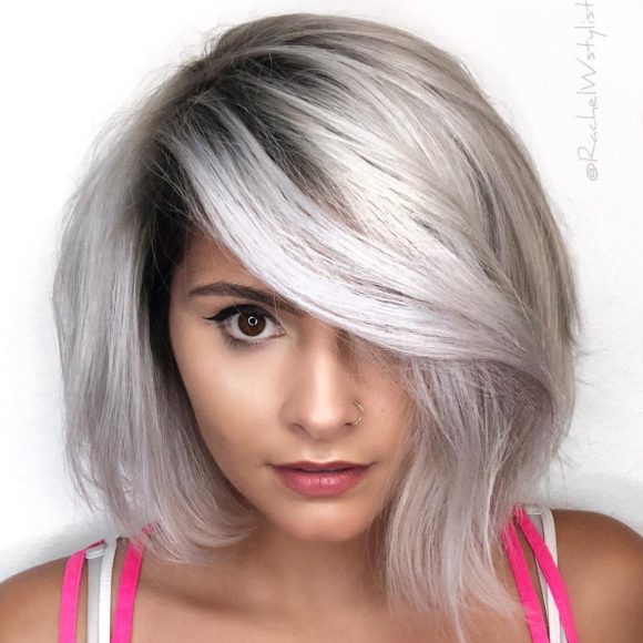 Smoky Silver Platinum Asymmetric Bob with Long Side Swept Bangs and Blowout Texture Medium Length Fall Hairstyle