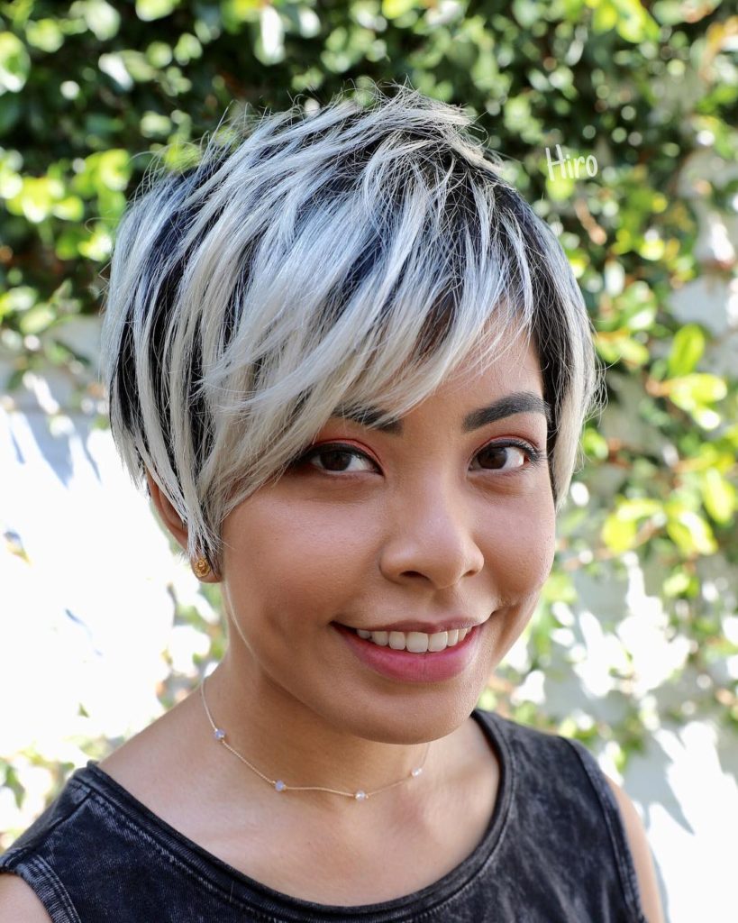 Textured Long Layered Pixie with Asymmetrical Side Swept Bangs and Platinum Blonde Highlights on Black Hair Short Summer Hairstyle