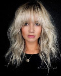 Voluminous Blonde Layered Lob with Face Framing Fringe and Messy Wavy Texture Medium Length Fall Hairstyle