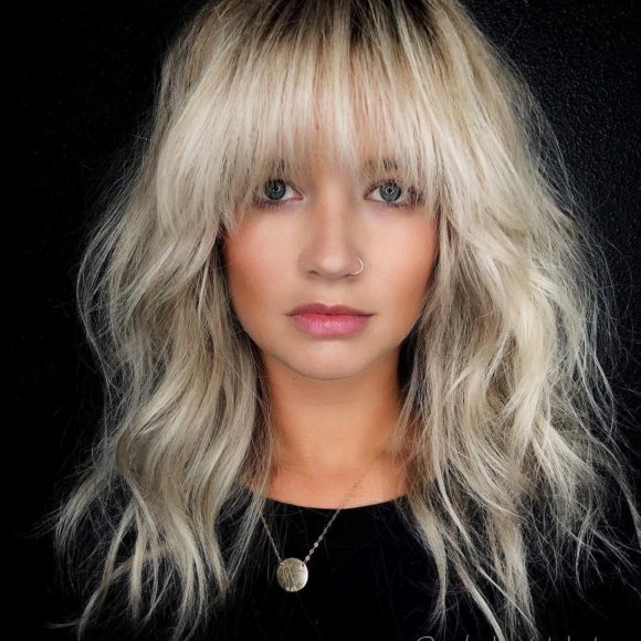 Voluminous Blonde Layered Lob with Face Framing Fringe and Messy Wavy Texture Medium Length Fall Hairstyle