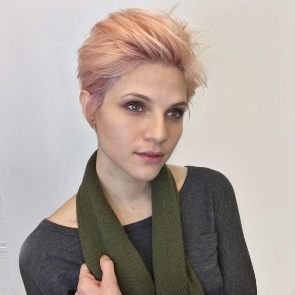 Voluminous Brushed Up Pixie with Messy Blowout Texture and Baby Pink Hair Color Short Fall Hairstyle