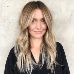 Wavy Layered Cut with Long Curtain Bangs and Soft Caramel Balayage Long Hairstyle