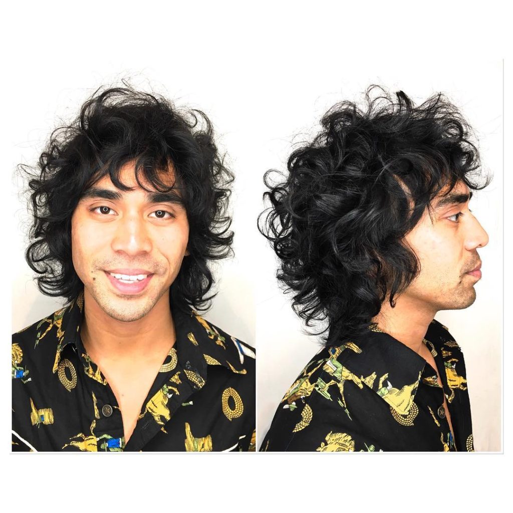 Wild Bohemian Curly Shag with Messy Texture and Jet Black Color Men's Summer Beach Hairstyle