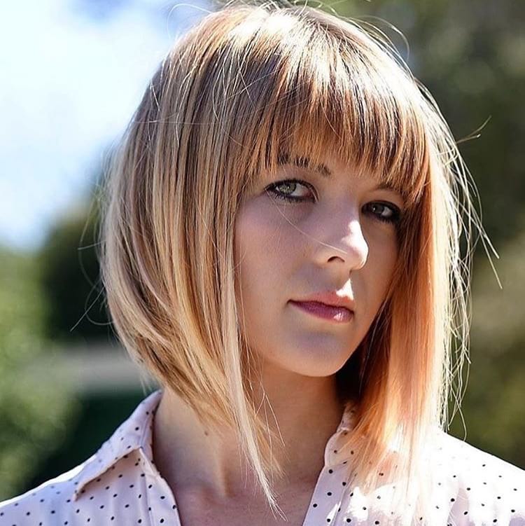 Long A Line Bob with Brow Skimming Fringe Bangs and Strawberry Blonde Color with Highlights