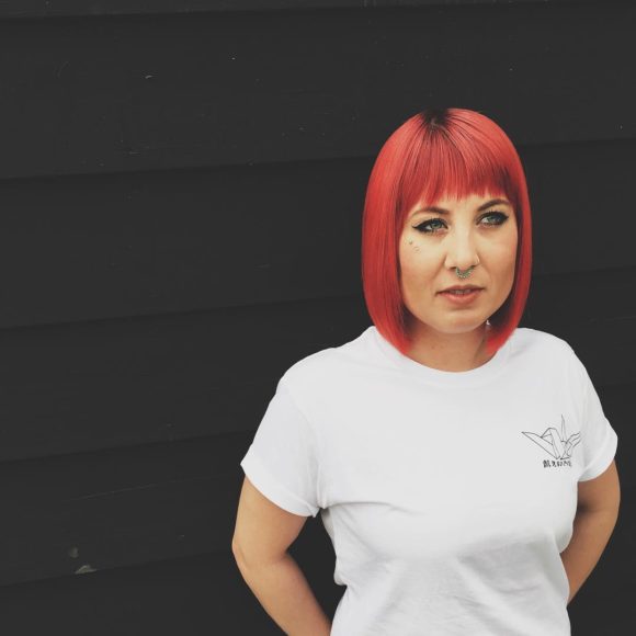 Blunt Bright Red Shoulder Length Bob with Brow Skimming Fringe Bangs