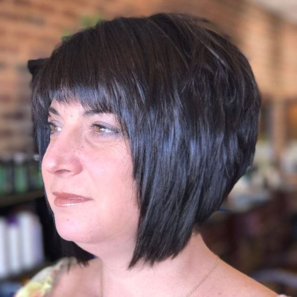 Short Black Angled Bob with Choppy Layers and Choppy Brow Skimming Bangs