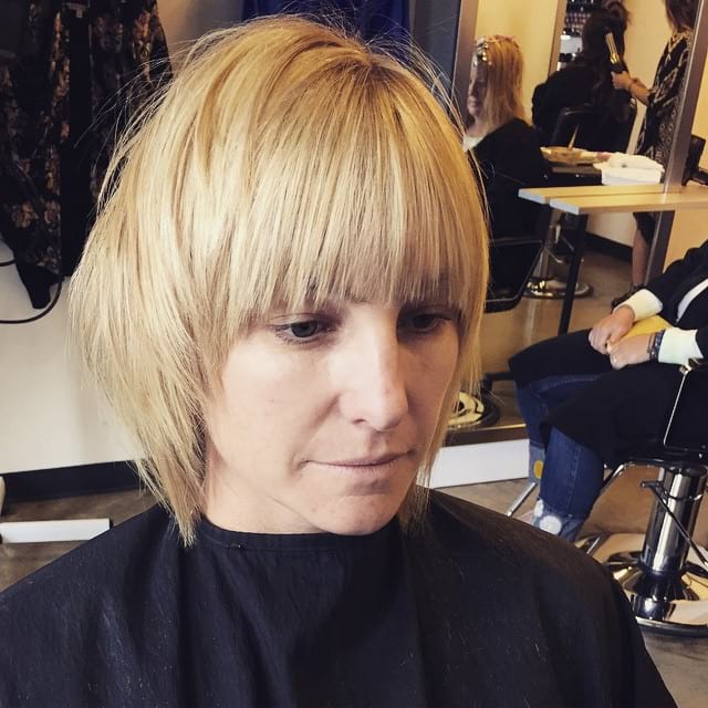 Short Blonde Shaggy Bob with Face Framing Textured Ends and Full Bangs