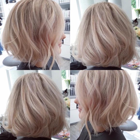 Blowout Angled Bob with Tousled Waves on Blonde Hair with Platinum Highlights