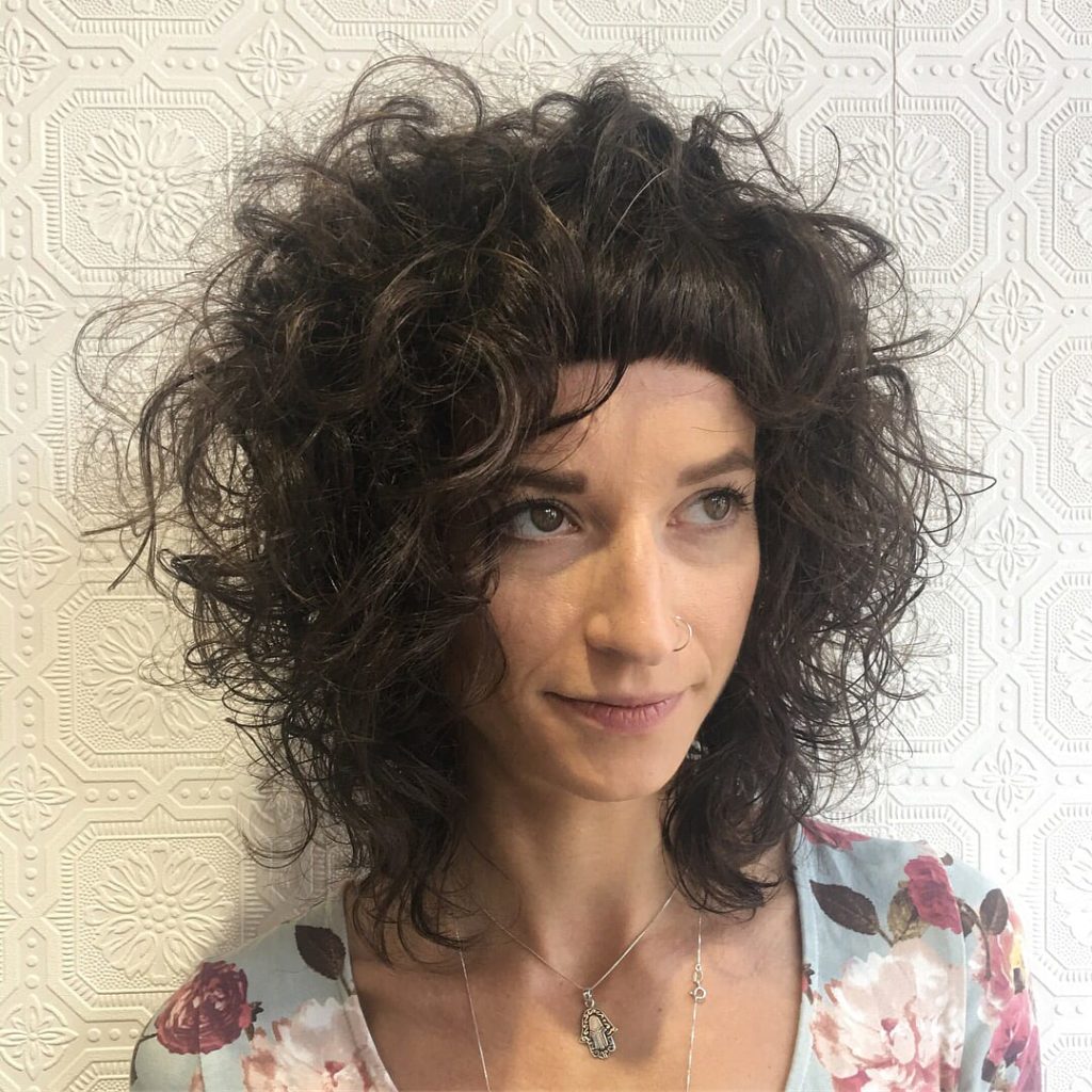 Messy Textured Curly Bob with Micro Bangs on Brunette Hair